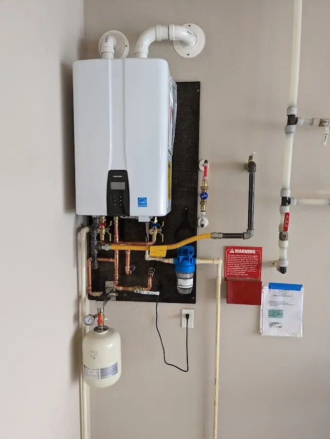 Professional plumber installing copper piping in a Quakertown home